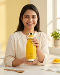 Woman holding a yellow bottle with 'Fresh Juice' text, smiling in a bright room.